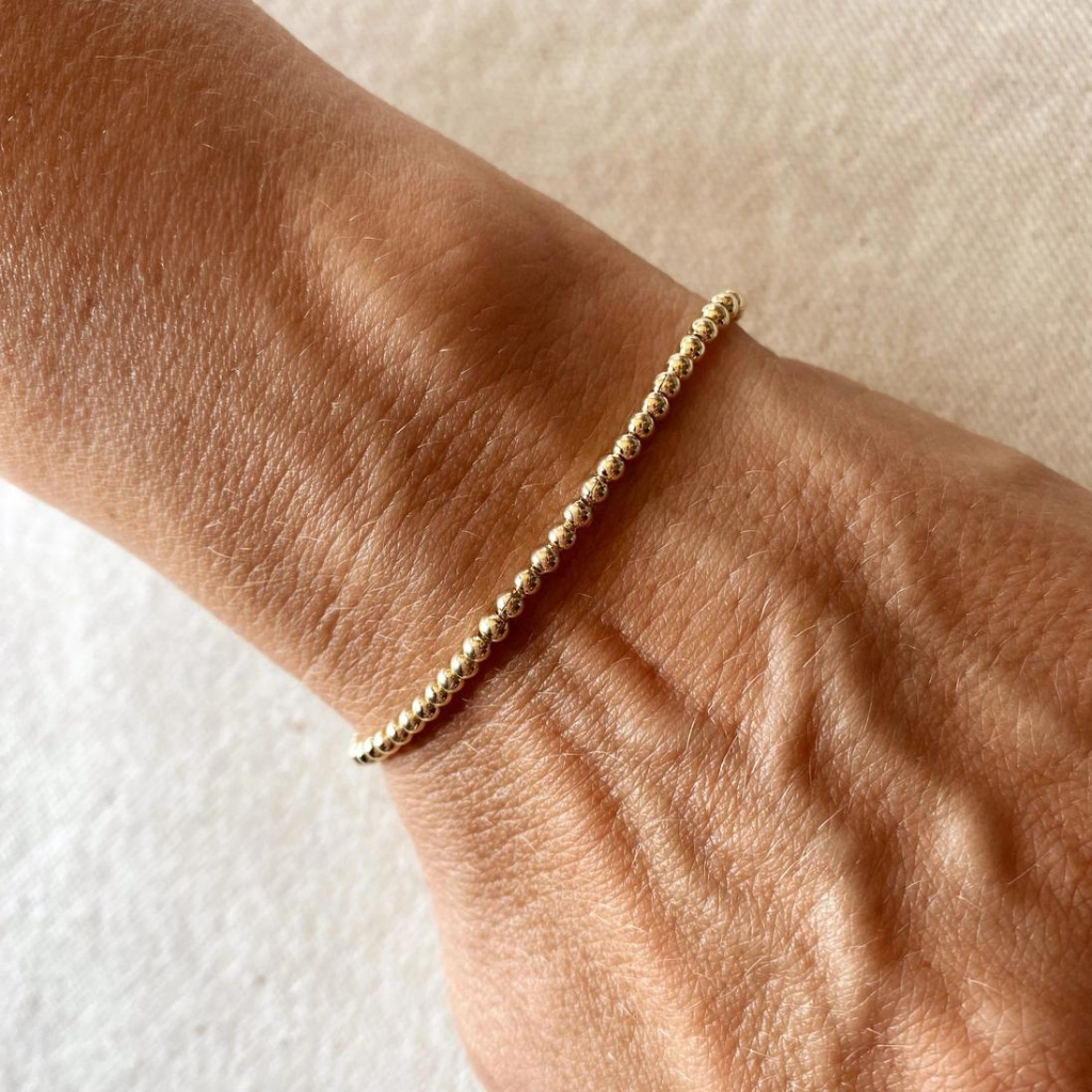 Add a touch of sophistication with our 18k Gold Filled 2.5mm Beaded Bracelet, featuring finely crafted beads for a timeless and elegant design. Perfect for any occasion, this versatile piece complements any outfit effortlessly.