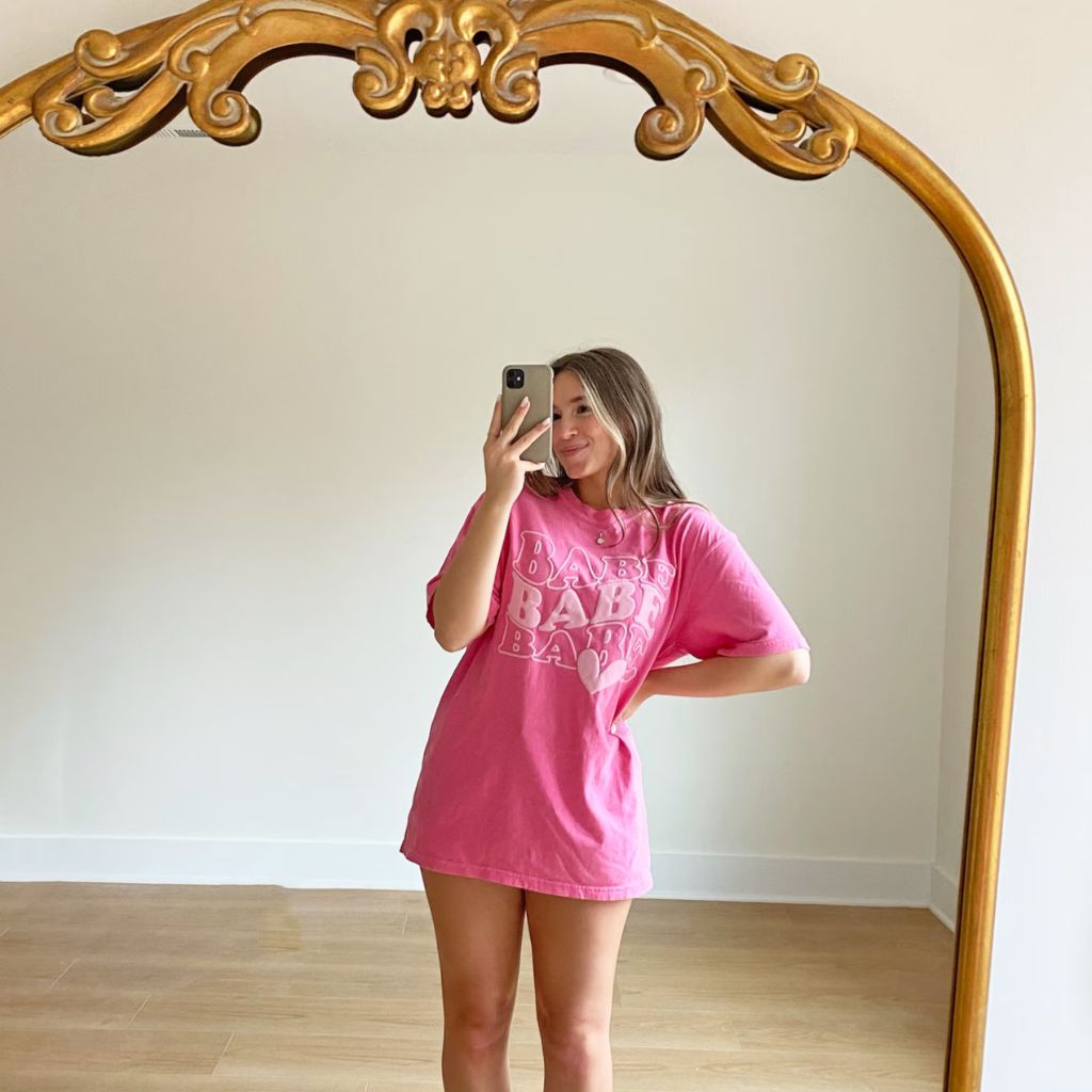 A pink t-shirt with the word "Babe" printed on it, designed for bridesmaid proposals. 