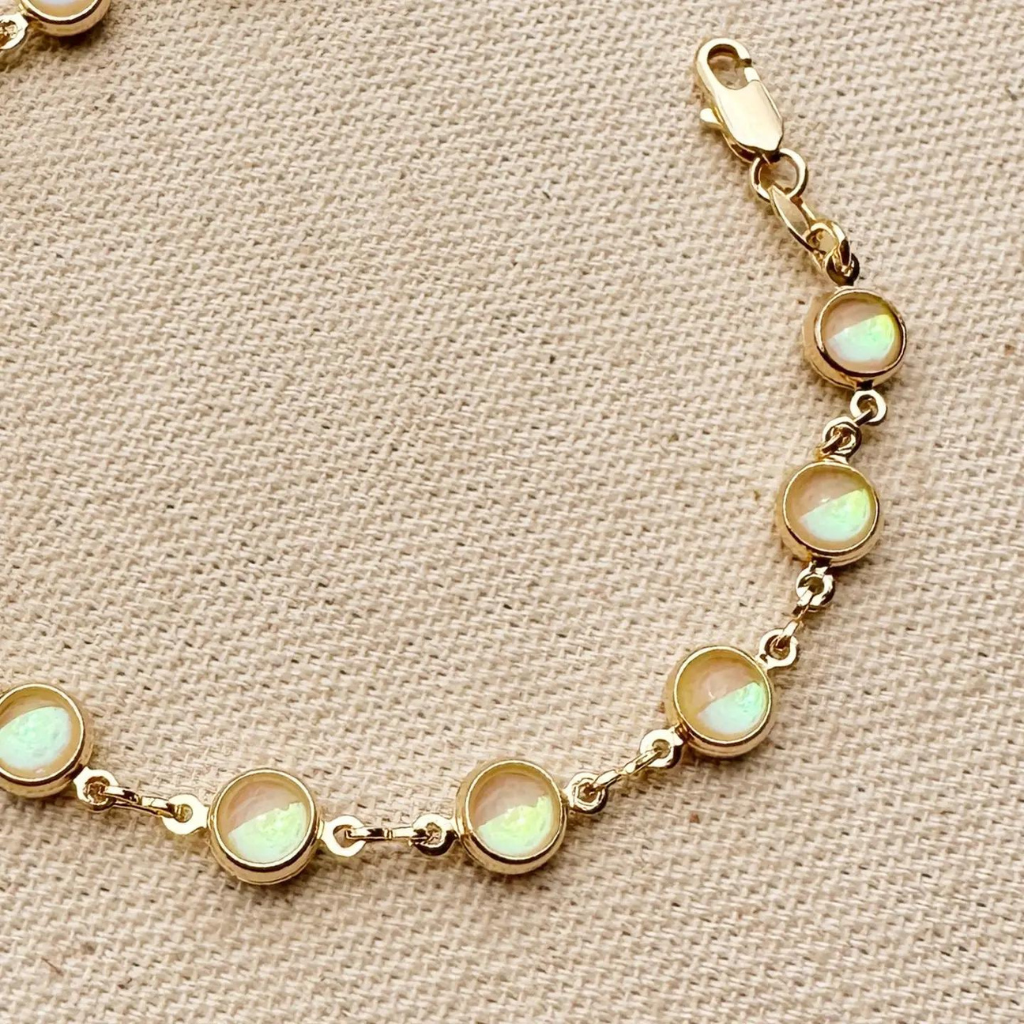 Discover elegance with our 18k Gold Filled Rounded Opal Bracelet, showcasing stunning opal stones set in a delicate gold design. Perfect for any occasion, this bracelet adds a touch of sophistication and charm to your look.