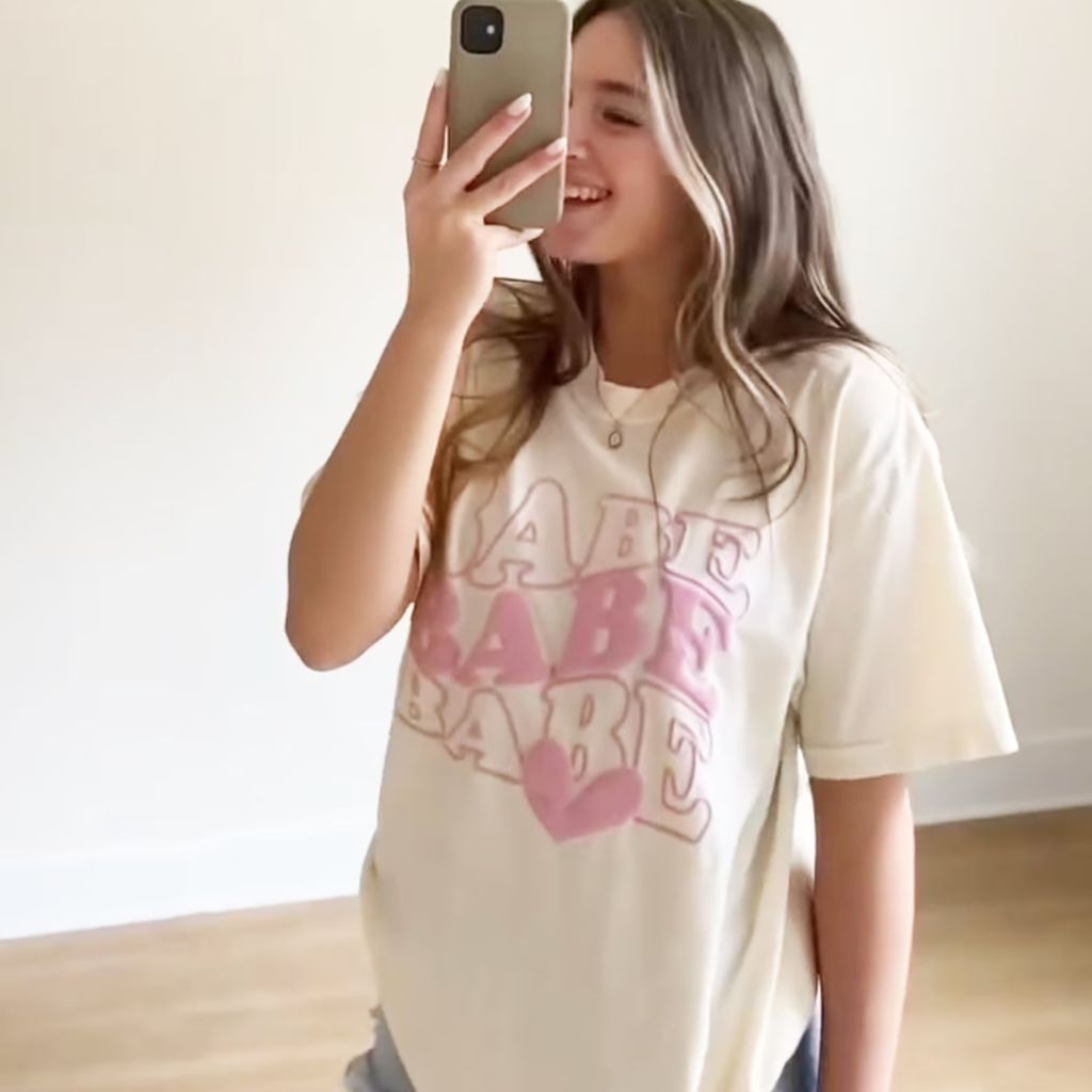 A white t-shirt with the word "Babe" printed on it, designed for bridesmaid proposals. 