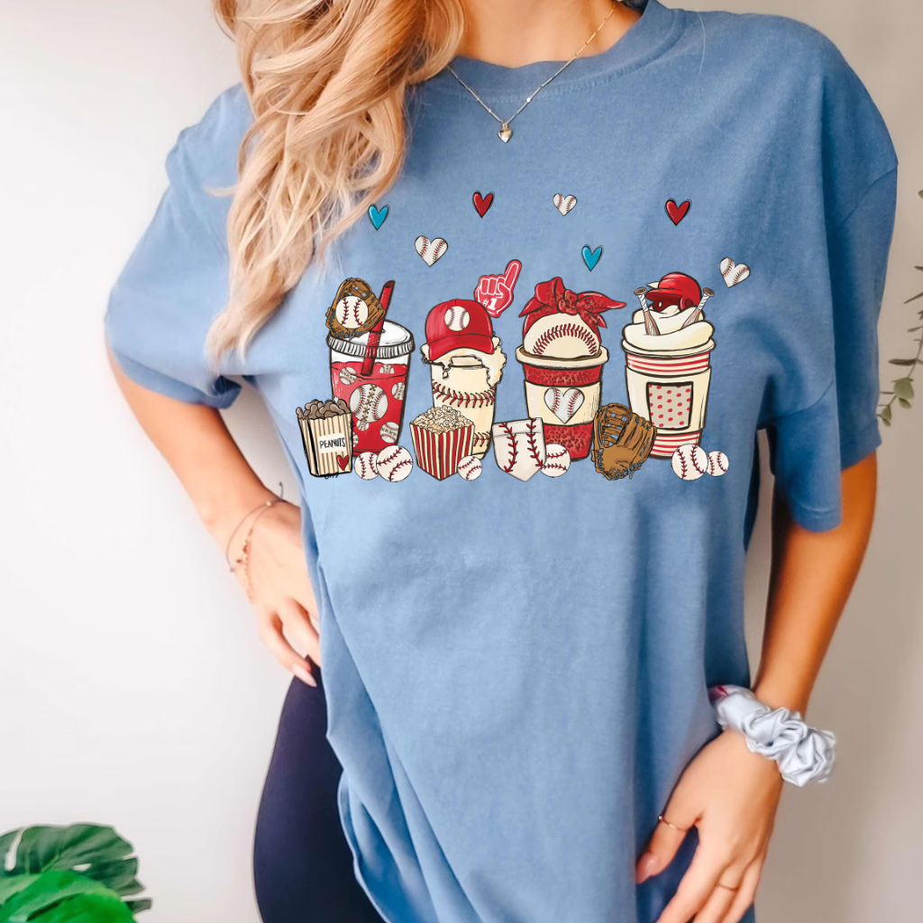 A women&#39;s graphic t-shirt with short sleeves, featuring Baseball Lattes design. This soft, comfortable short sleeve tee from Comfort Colors is perfect when watching your favorite Baseball game. It is available in white with pink font or pink with white font, in sizes Small to 2XL.