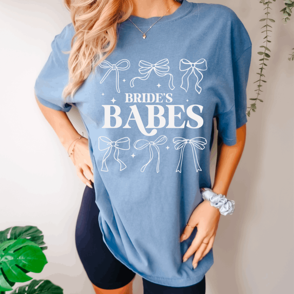 Bride's Babe Comfort Colors Tee – Oversized preppy bachelorette party t-shirt featuring a bold 'Bride's Babe' graphic. Made from soft, garment-dyed cotton for a relaxed fit. Perfect for bridal parties, wedding festivities, or casual wear. Shop bridal apparel at Melody Faye."