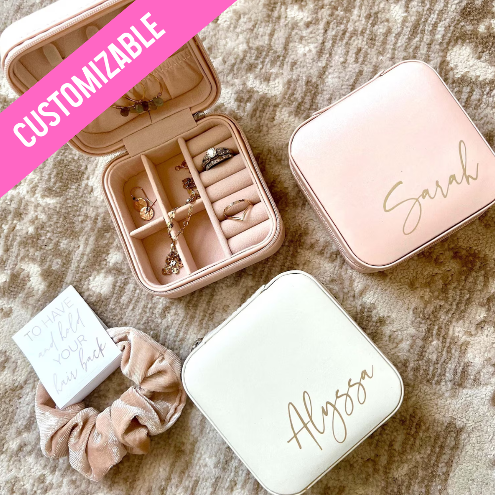 A personalized jewelry box designed for bridesmaids, available in three colors with options for three font colors. This travel-friendly box is stylish and practical, with compartments to hold jewelry securely. It makes an ideal gift for bridesmaids, perfect for storing jewelry while on the go, and can be personalized with names or monograms.