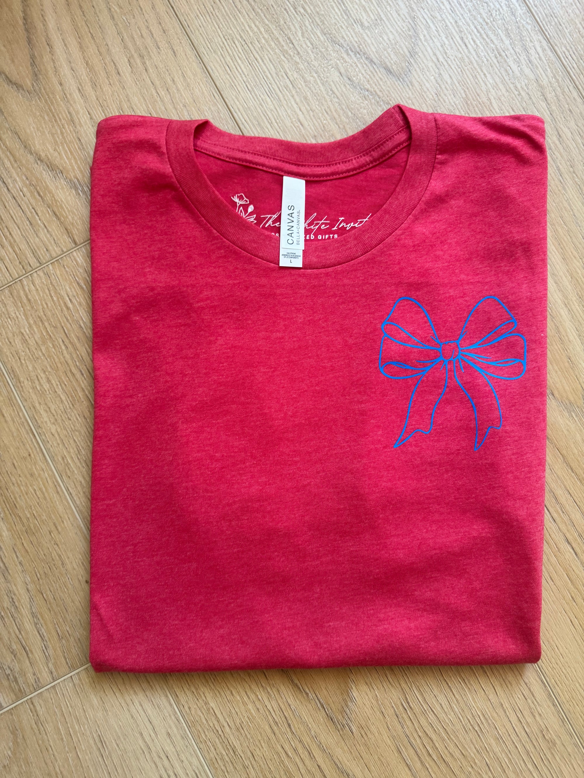 Bella Canvas tee featuring a patriotic bow design for the 4th of July. This soft, comfortable t-shirt is perfect for celebrating Independence Day with style and flair.