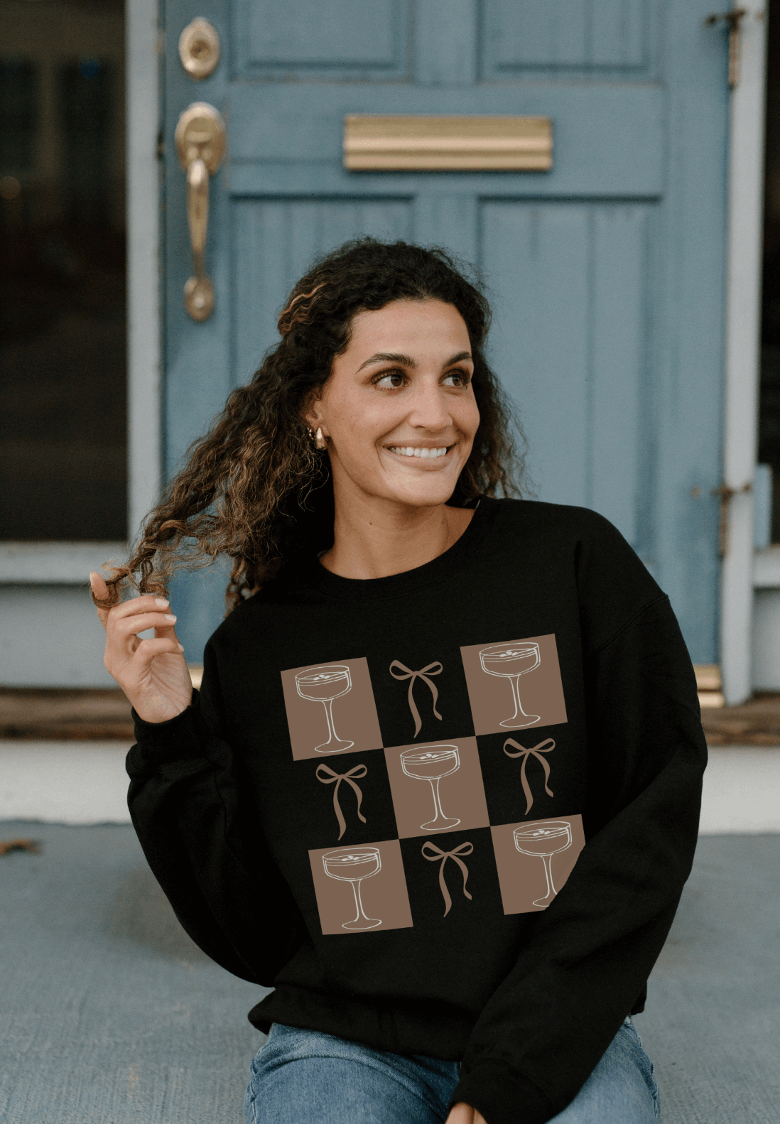 Celebrate in style with the Bow & Espresso Martini Checkered Sweatshirt from Melody Faye. This festive Gildan sweatshirt combines playful clovers and delicate bows, making it perfect for St. Patrick's Day celebrations or adding a touch of charm to your everyday wear.