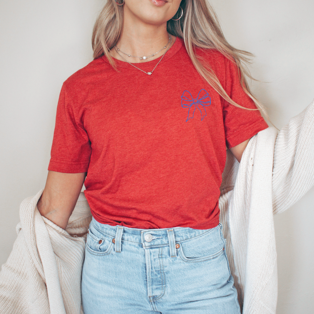 Bella Canvas tee featuring a patriotic bow design for the 4th of July. This soft, comfortable t-shirt is perfect for celebrating Independence Day with style and flair.