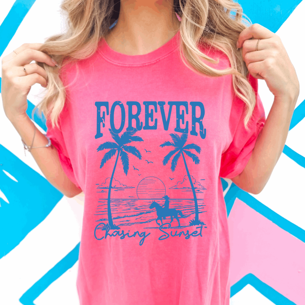 Embrace the free-spirited vibe of coastal sunsets with the Forever Chasing Sunset Comfort Colors Graphic Tee from Melody Faye. This tee features a vibrant, retro-inspired design combining dreamy sunsets and palm trees, capturing the essence of a wild heart with a coastal twist. Crafted from soft, garment-dyed cotton, it offers a relaxed, unisex oversized fit that's perfect for beach outings, road trips, or your next golden hour photo op.​
