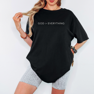 Person wearing a black t-shirt with 'GOD > EVERYTHING' text on a white background