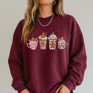 Maroon sweatshirt with festive cup and gingerbread design on a plain background