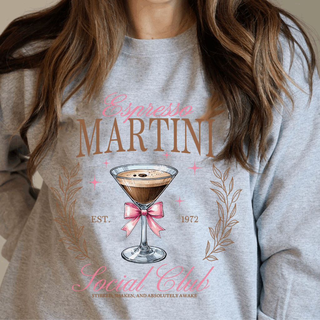 For those who enjoy a blend of caffeine and cocktails, the Espresso Martini Social Club Sweatshirt is the perfect attire. Crafted from ultra-soft Gildan fabric, this sweatshirt offers a relaxed fit, making it ideal for brunch dates, girls' nights, or cozying up with your favorite espresso martini.