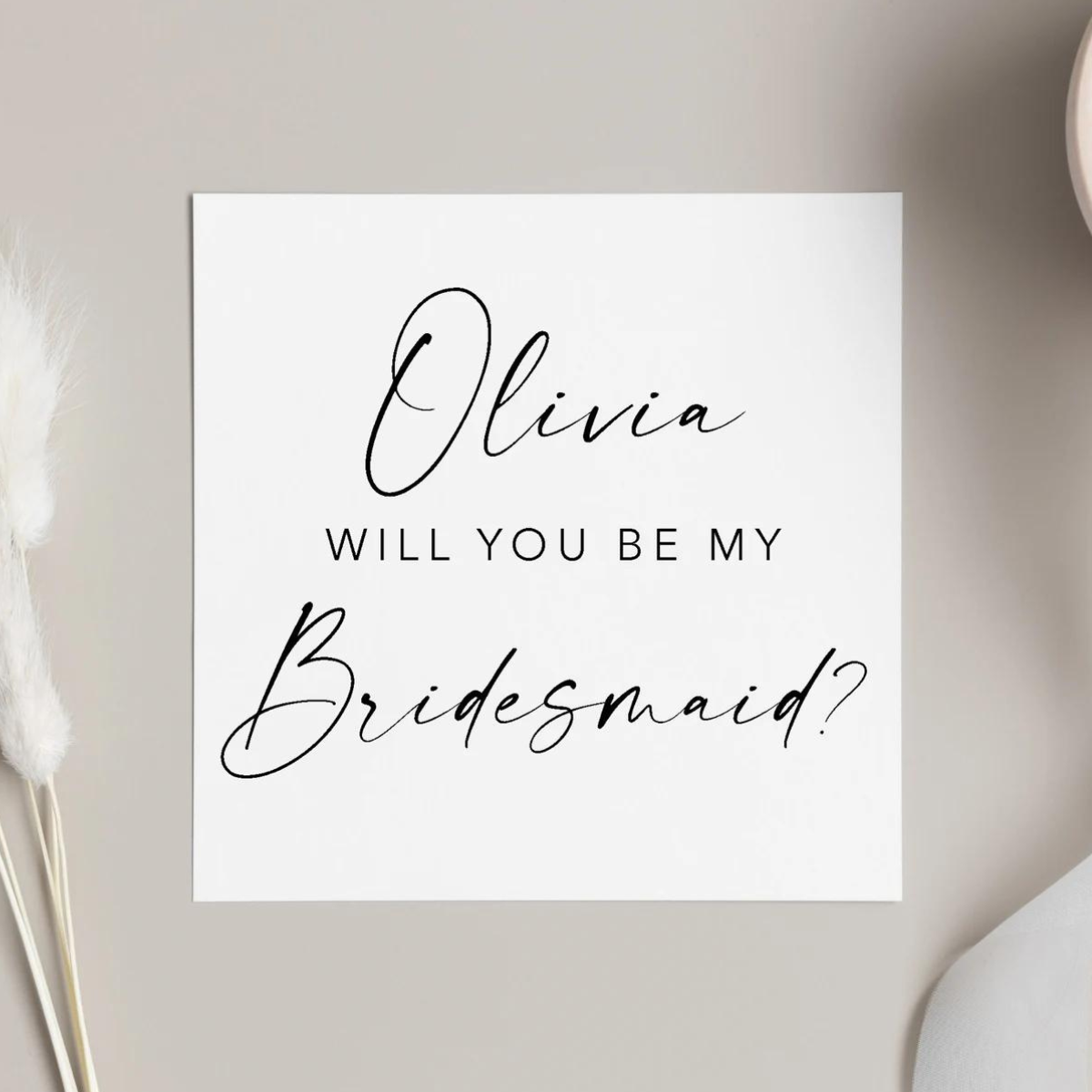 "Will You Be My Bridesmaid?" proposal card featuring classic black font. 